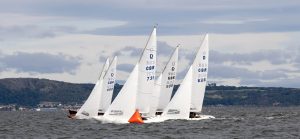 Four Dragon keelboats racing in Scotland on Firth of Forth